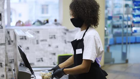 portrait of an african american worker at grocery store checkout