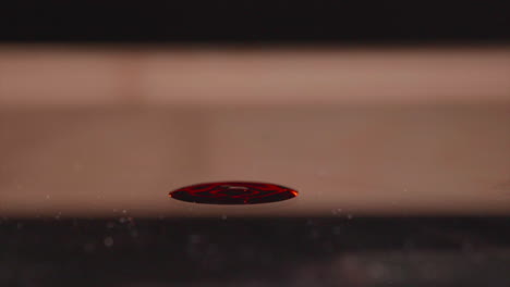 thick red blood dropping on surface