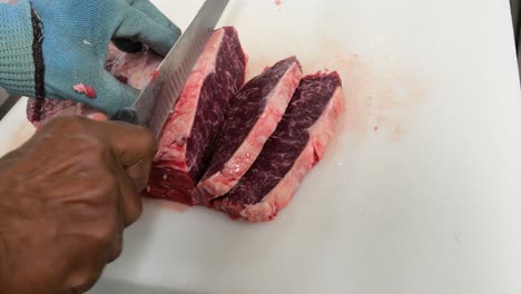 chef portioning new york strip steak