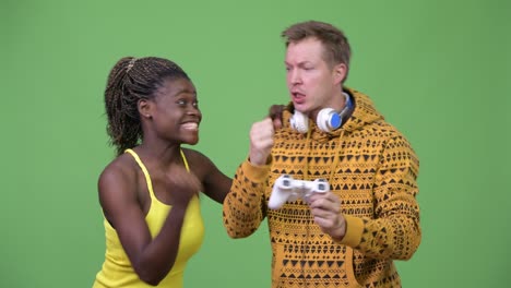 young multi-ethnic couple playing games together