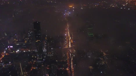 aerial view of a foggy city at night