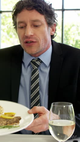 frustrated man holding a plate of meal in restaurant