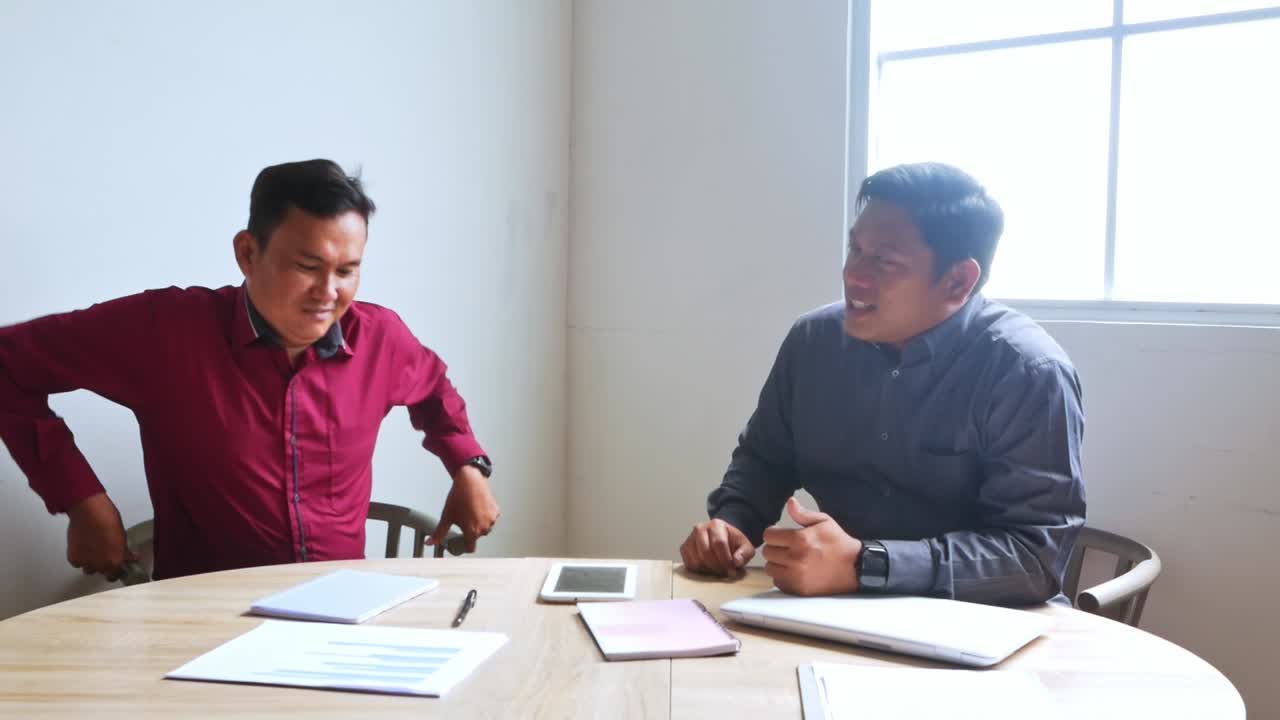 Confident employees collaborating on business strategy while discussing growth in modern office setting