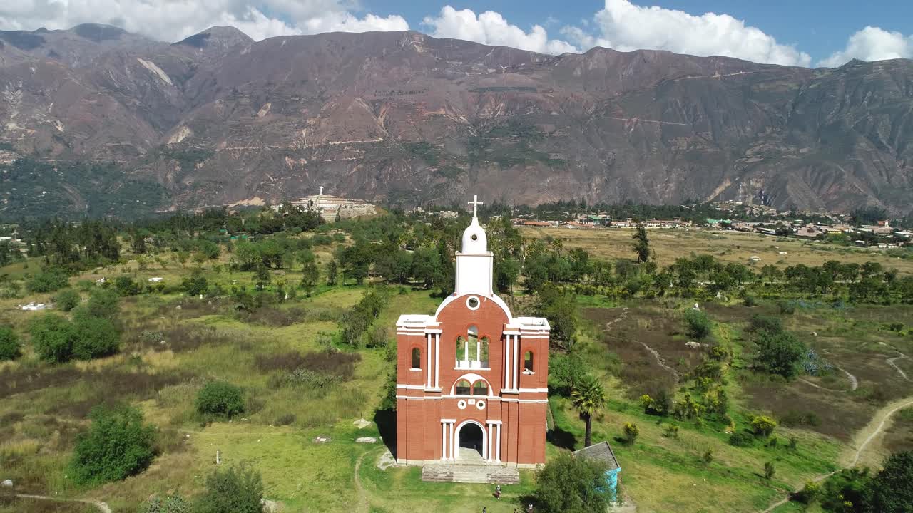 Stunning aerial shot of the church at Yungay Cemetery, Áncash, Peru, framed by the majestic Andean mountains. A historic and spiritual memorial site honoring the 1970 earthquake victims