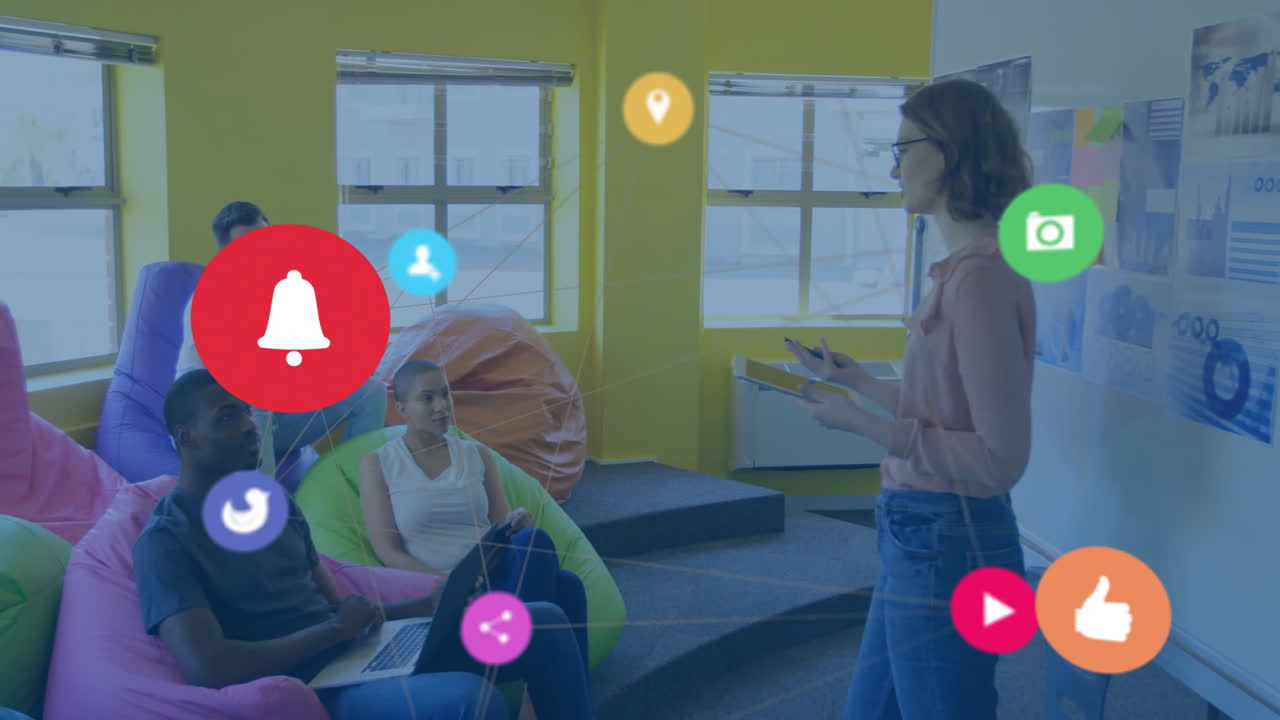 Marketing team collaborating on bean bags in office, brainstorming with floating social media icons