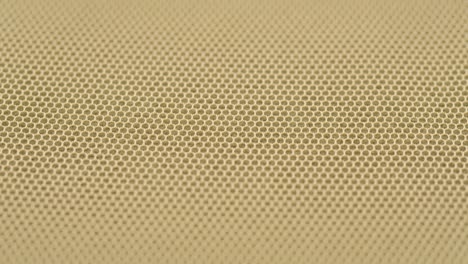 beige fine mesh close-up. sewing a wedding dress. light veil nylon. handmade tailoring, professional clothing concept. abstract background