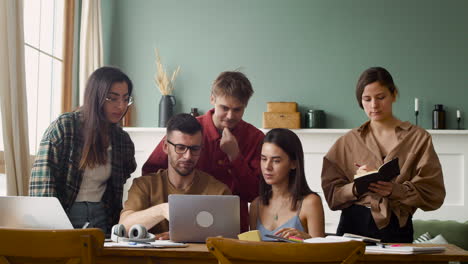 study group at a table standing and sitting at home