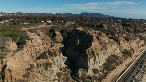 rising aerial view of san clemente state park and the jagged cliffs in southern california