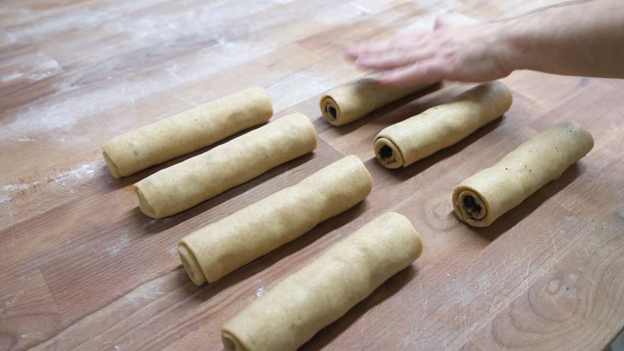 준비 도중 목재 표면 에 정렬 된 몇 개 의 끔 히 굴러진 원시 베글리 반죽 줄기