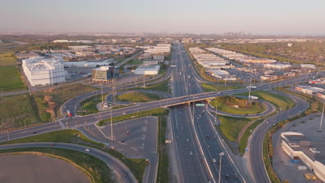 aerial shot of a highway interchange with trucks and cars on mississauga's 401