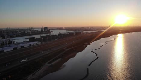 beautiful yellow sunset reflection on calm waters in brielse meer at maasvlakte port of rotterdam in netherlands