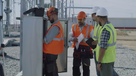 electrical engineers inspecting power plant equipment