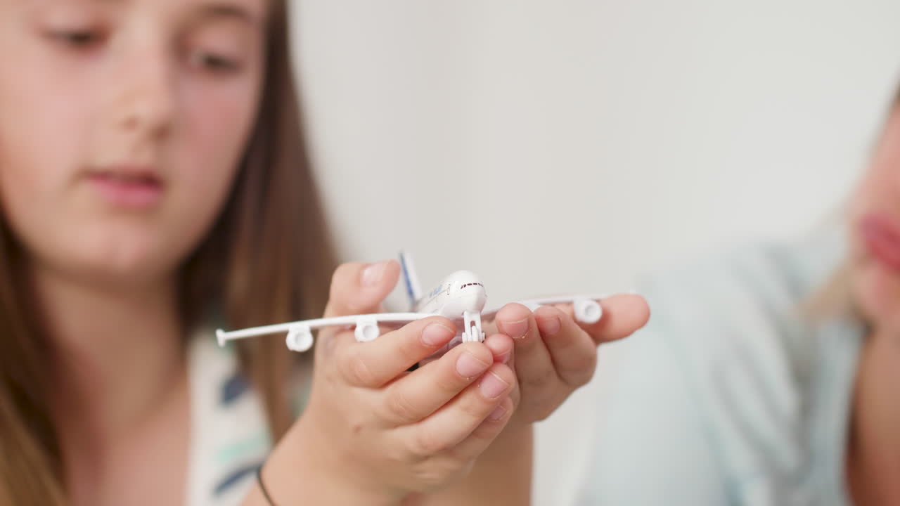 Child and Mother Playing with Toy Airplane