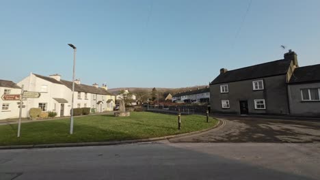 editorial footage of the cumbrian village of cartmel in the english lake district. showing traffic and tourists walking and shopping