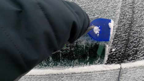 scraping ice from frozen car side window