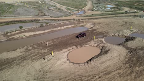 Four-wheel-drive-car-drives-through-a-mud-pit-at-Prairie-City-Off-Highway-motor-vehicle-recreation-at-the-foothills-of-California