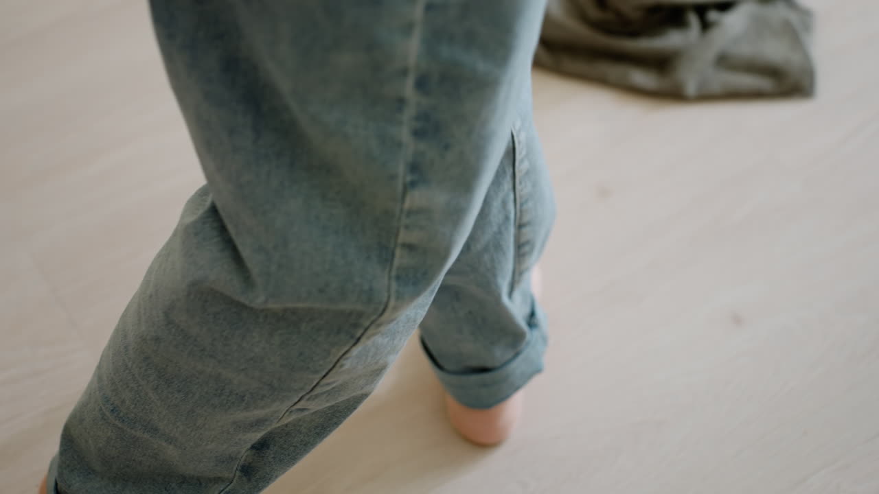 Close up of person cleaning wooden floor with mop showing movement and focus on household task, daily sanitation, hygiene, routine work, cleanliness, and effort in maintaining tidy home
