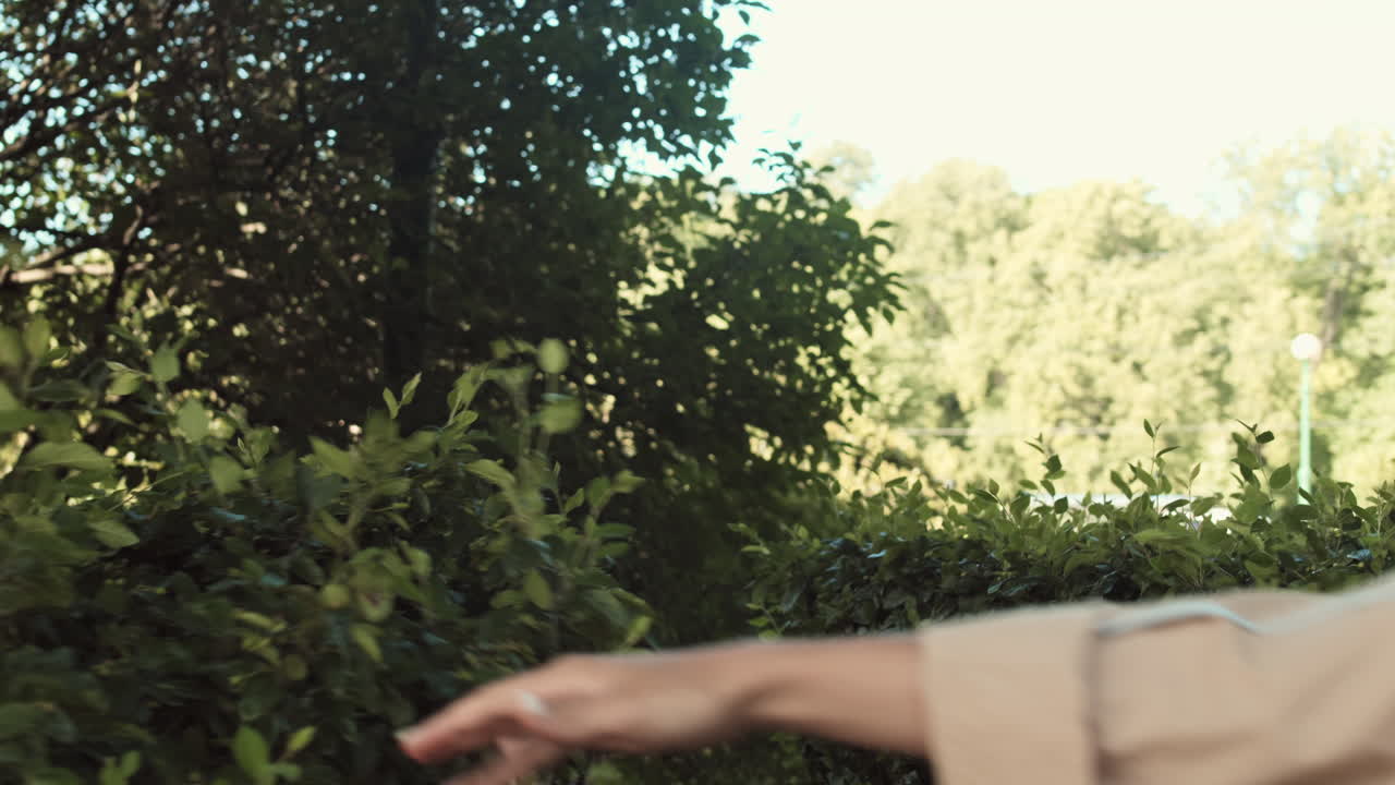 Happy Woman Walking Through Bushes