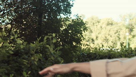 happy woman walking through bushes