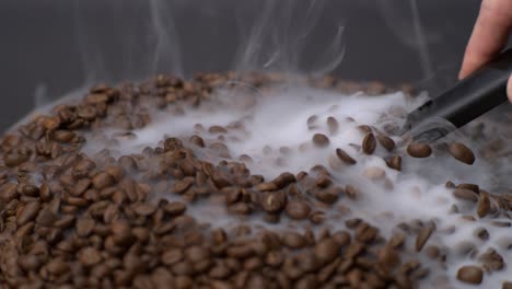 close up of a coffee spoon scooping some coffee beans in super slow motion 1000fps