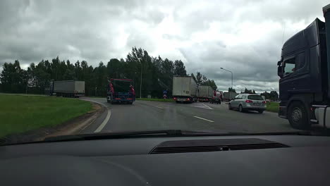 Industrial-Trucks-Driving-On-The-Road-With-Traffic-Jam-On-A-Cloudy-Day