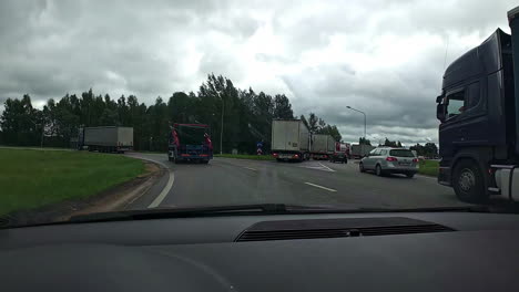 industrial trucks driving on the road with traffic jam on a cloudy day