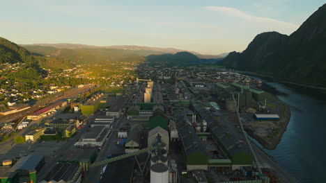 Aerial-view-over-Mosjøen-industrial-aluminium-plant-during-midnight-sun,-Norway