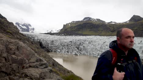 iceland glacier with man standing and gimbal video walking forward in slow motion