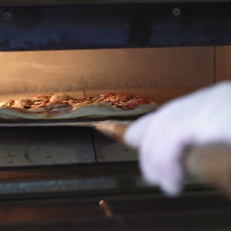 chef puts a raw pizza into the oven. making pizza. cooking food. sqare video