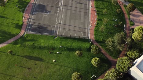 zenithal shot of people playing in the park with dolly in