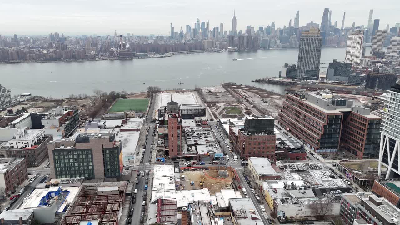 Horizontal drone orbit over Williamsburg, Brooklyn, featuring a sweeping aerial view of New York’s iconic cityscape, historic landmarks, and vibrant waterfront area.