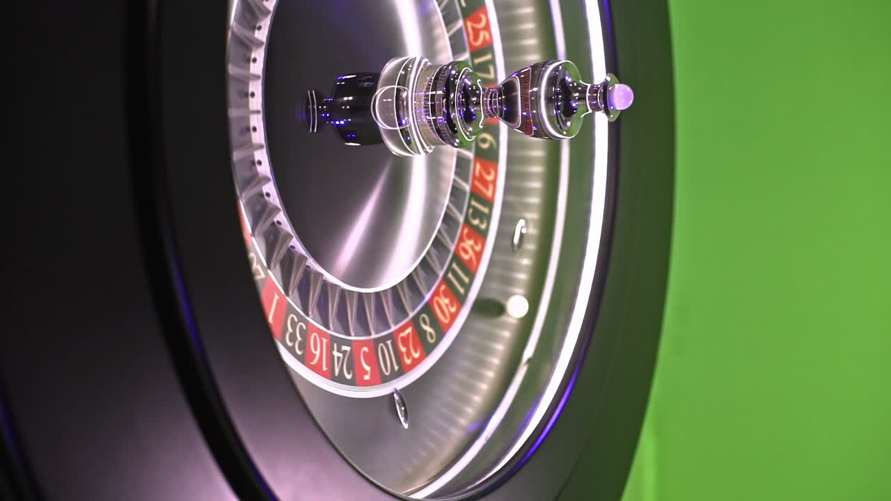 Metallic roulette wheel spinning, ball bouncing across green screen background, showcasing casino gambling dynamics without players