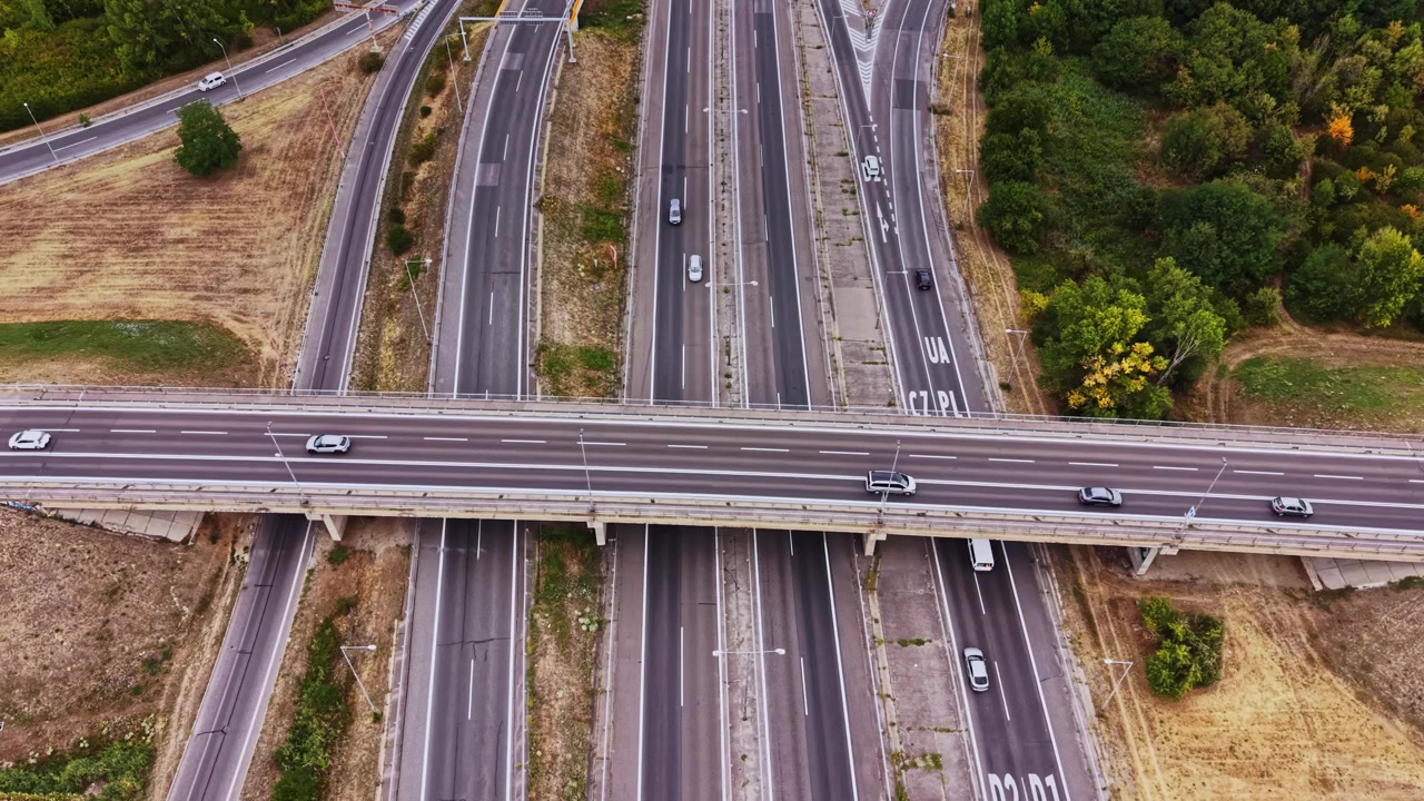 Highway interchange with empty lanes and nearby greenery
