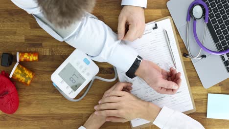 medical professional measuring a patient's blood pressure during a check-up