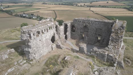 ruins of medieval castle in rural ireland - aerial pullback