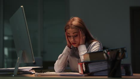 woman working and experiencing stress in office late at night
