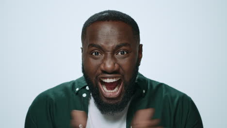 Portrait-of-scared-african-man-posing-with-positive-emotion-in-studio.