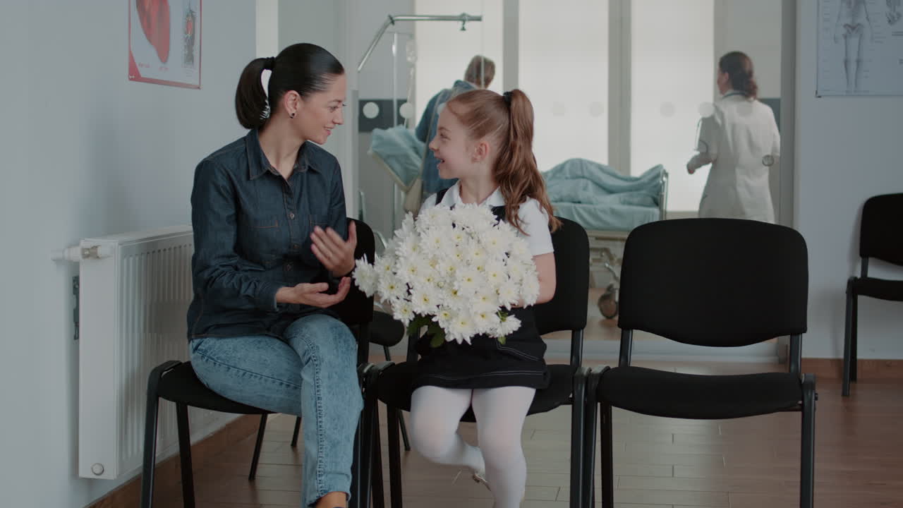 Woman and little girl preparing to visit patient in waiting room