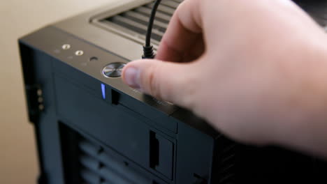 man unplugs multiple usb cables from desktop computer