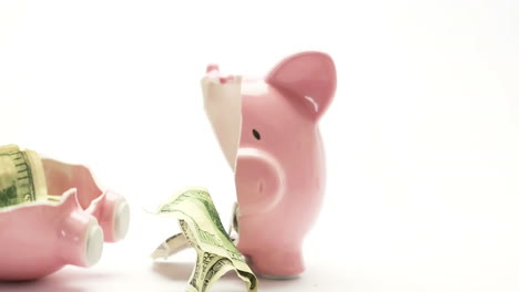 piggy bank splitting in two with cash inside