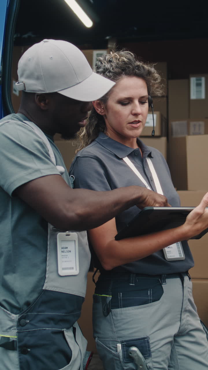 Delivery workers checking packages in a truck
