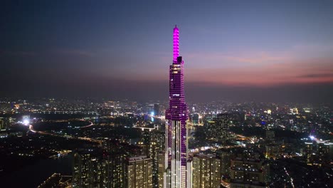 aerial close up of landmark 81 in ho chi minh city vietnam surrounded by modern skyline at night