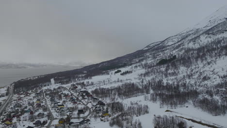 Olderdalen-town-nestled-at-foot-of-mountain,-freezing-snowy-landscape