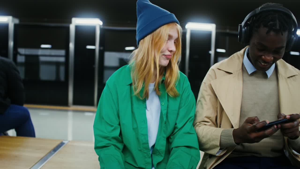 Friends enjoying mobile games in the subway