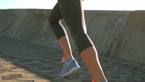 Bottom-section-of-a-sporty-woman-jogging