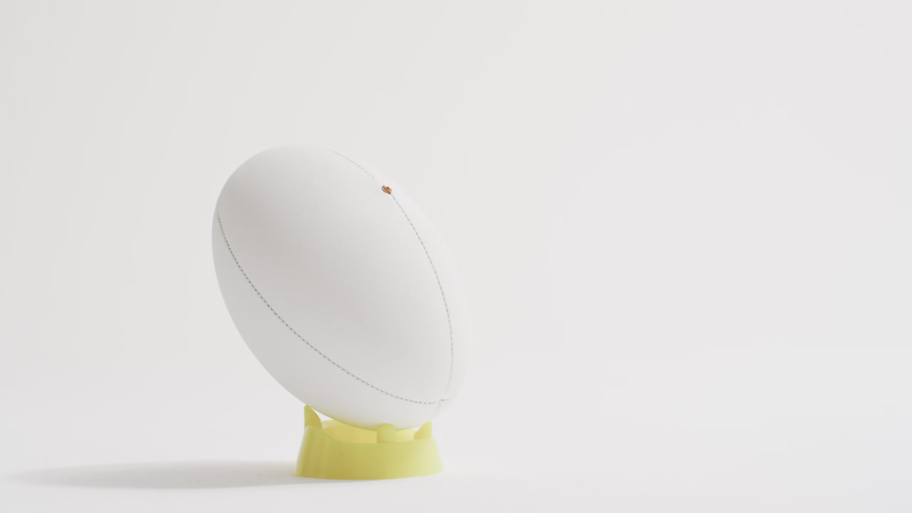 белый мяч для регби на белом фоне с копировальным пространством, замедленное движение