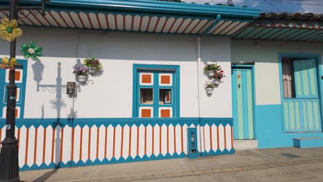 POV-shot-walking-on-streets-in-front-of-vivid-houses,-in-sunny-Quindio,-Colombia