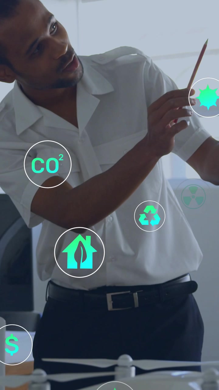 Engineer adjusting drone model and pointing, causing green icons around solar panel showing metrics
