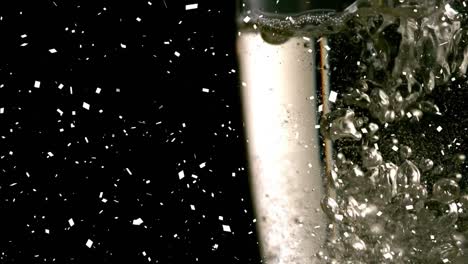 animation of confetti falling and bubbles rising in glass of champagne on black background