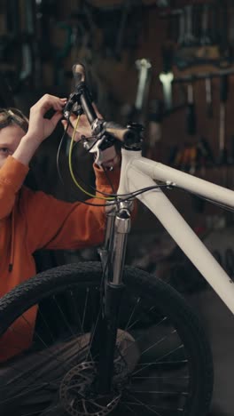 person repairing a mountain bike in a workshop